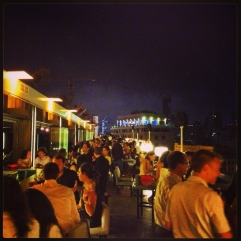 Bustling nightlife at the rooftop bar and restaurant Le Capitole